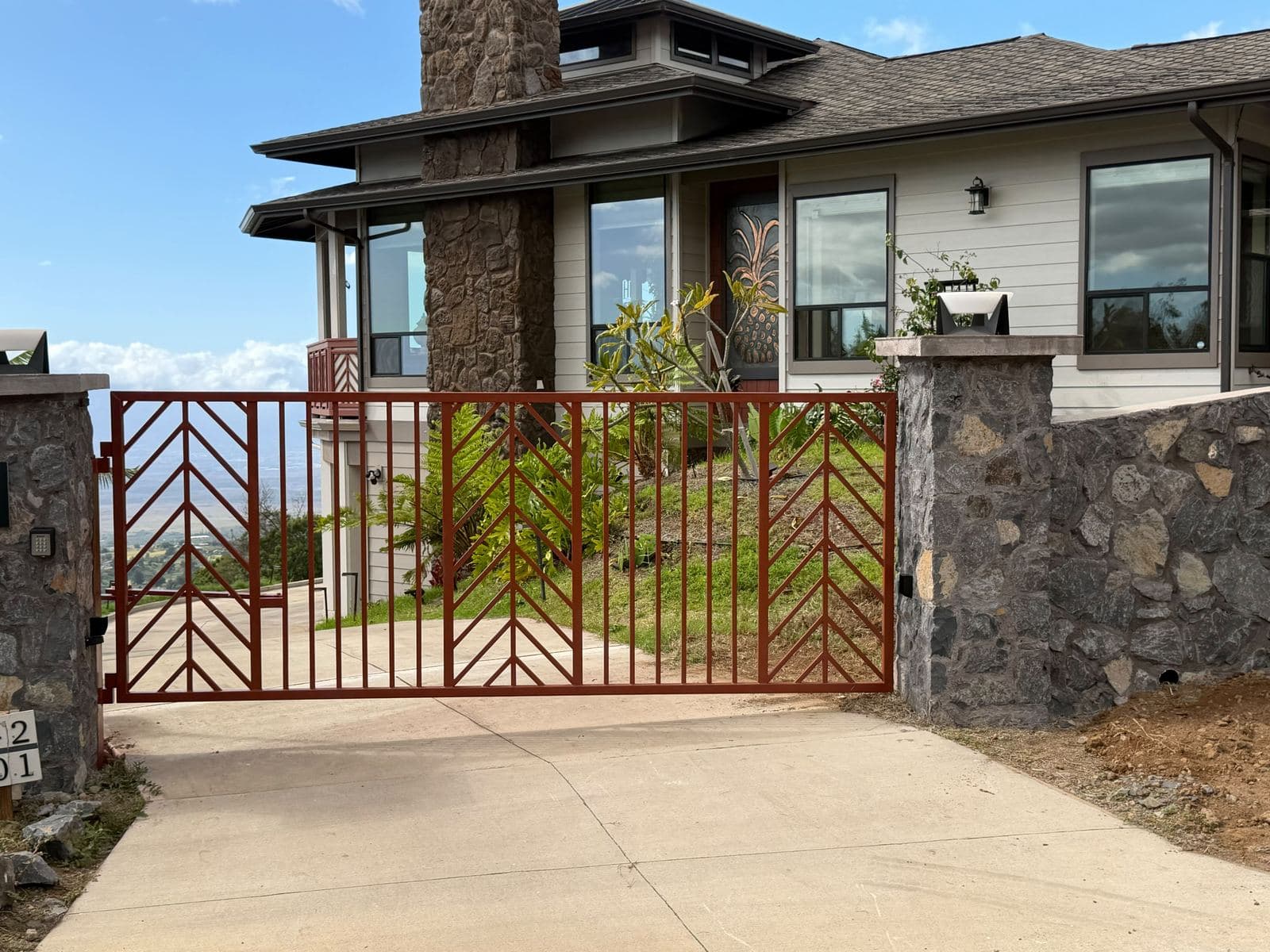 Rust Red Chevron Swing Gate with Lava Rock Pillars — Maui